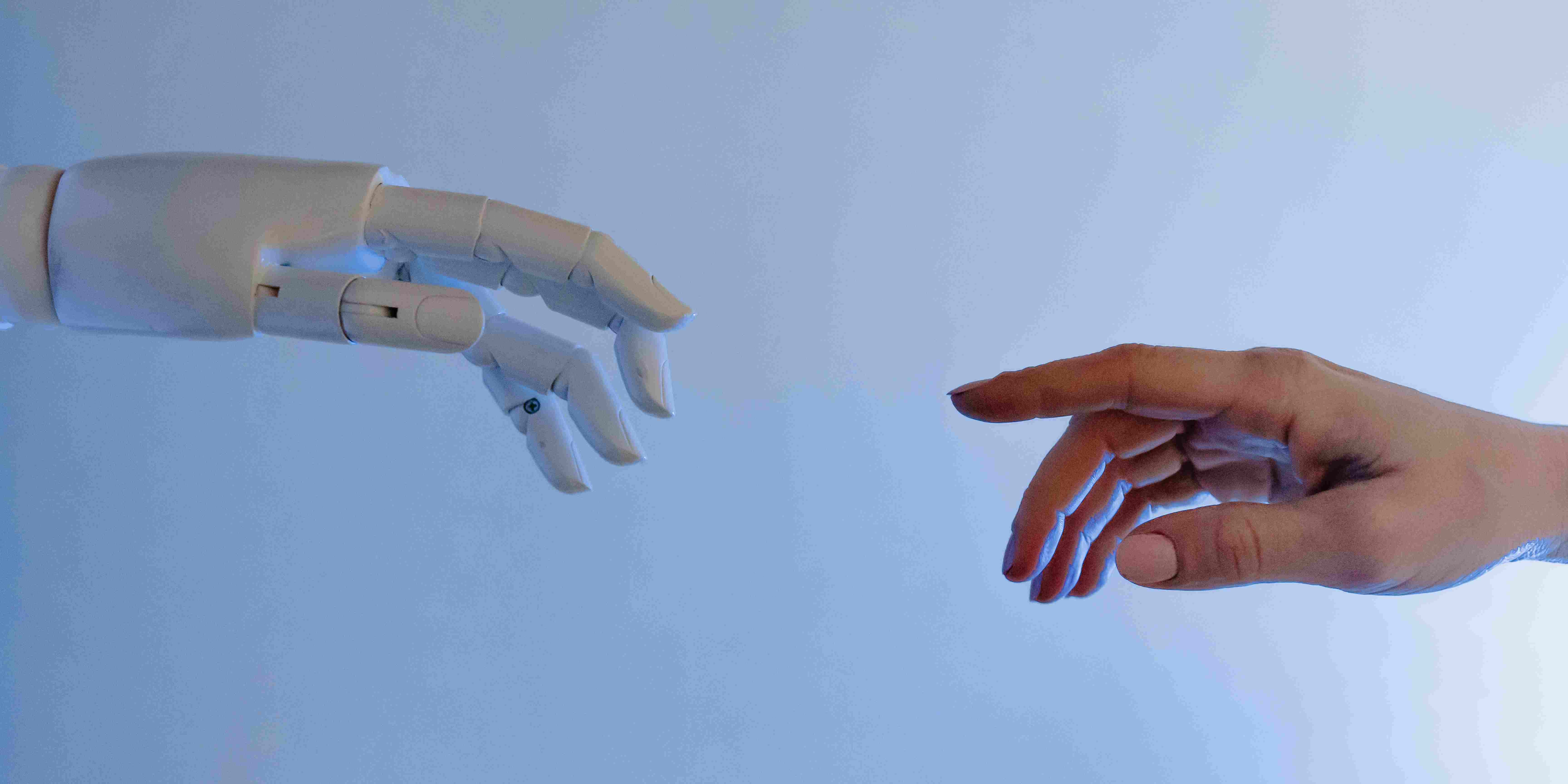 Person reaching out to robot, illustrating 2024 digital marketing trends